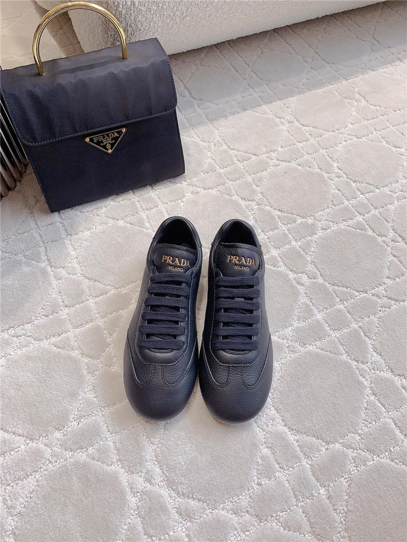 Pra*a triangle logo sneakers in black